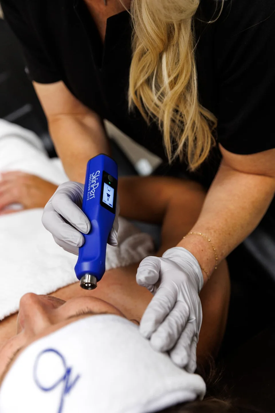 Provider performing SkinPen microneedling on a client's forehead at Lemonade Aesthetics in Manhattan, KS