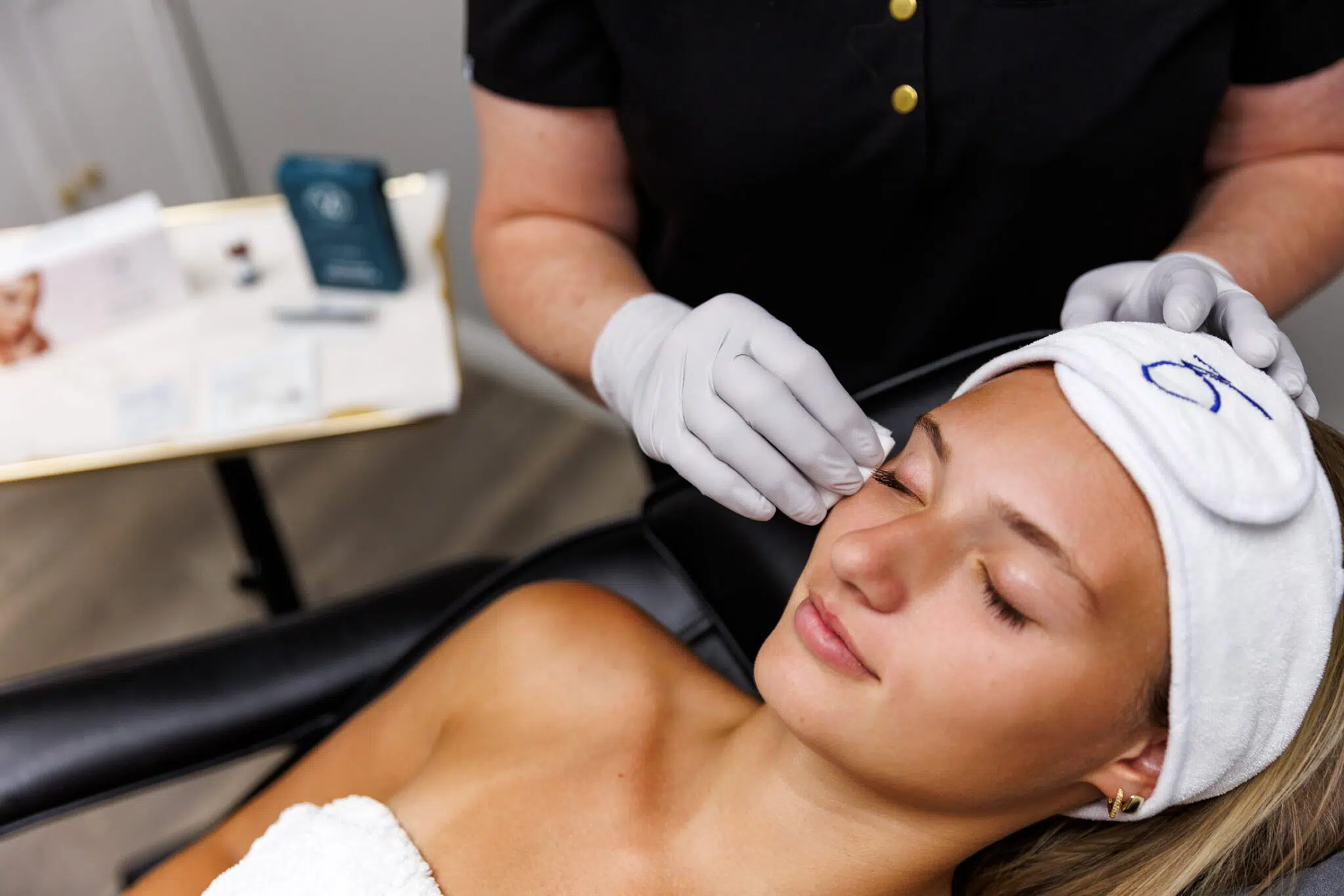 Woman receiving relaxing facial skin treatment